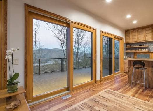 Wood-framed sliding glass doors with a mountain view